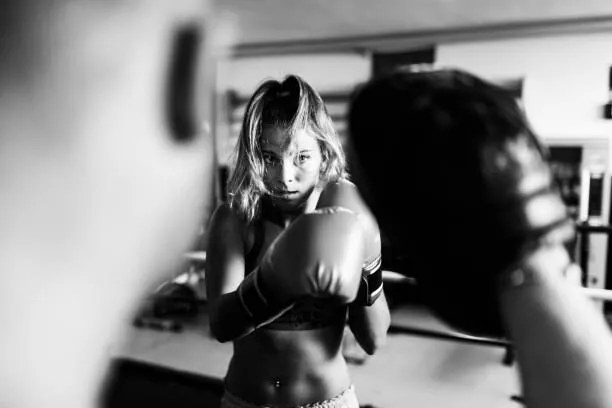 Fotografie Woman boxer workout with coach, massimo colombo