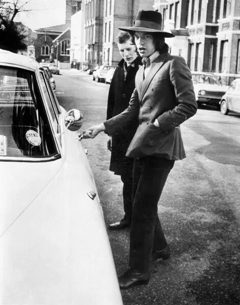 Fotografie Jagger, singer with the Rolling Stones, about to get into his car, c.1970