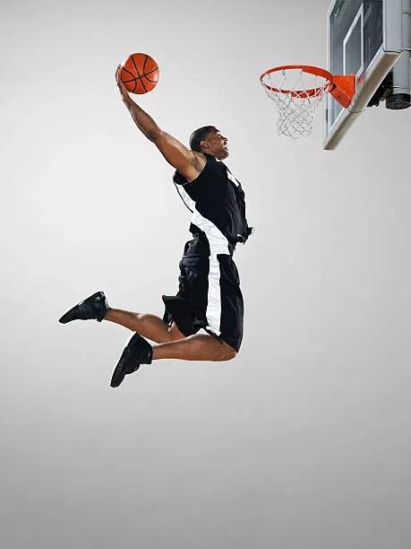 Fotografie Basketball player dunking ball, low angle view, Blake Little