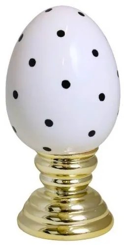 Ou mare alb cu buline negre pe un suport auriu din ceramica
