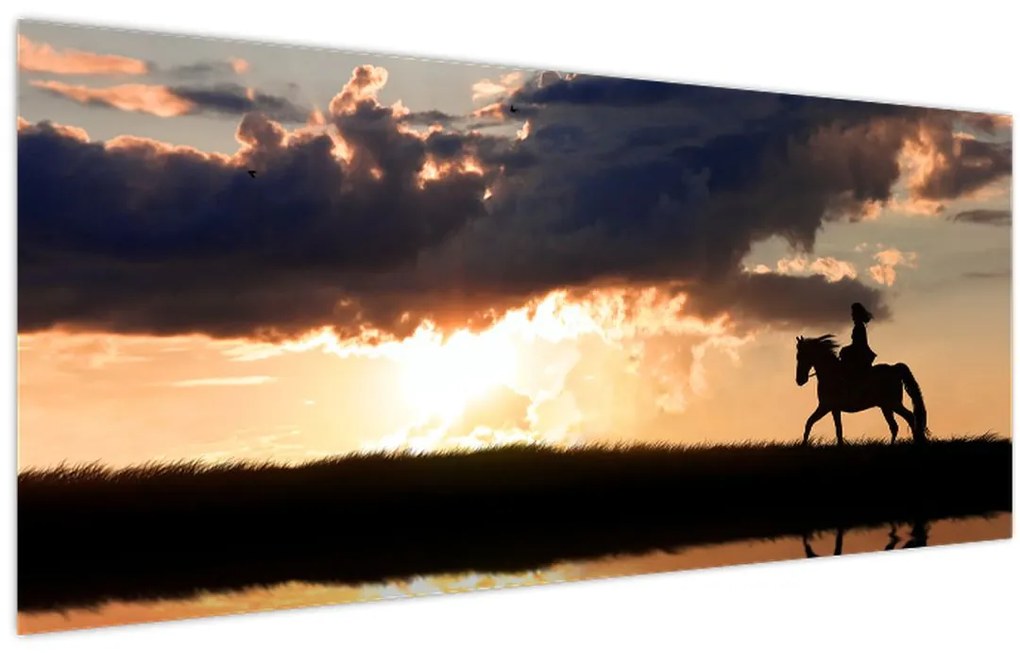 Tablou - Rider pe un cal la apus de soare (120x50 cm)