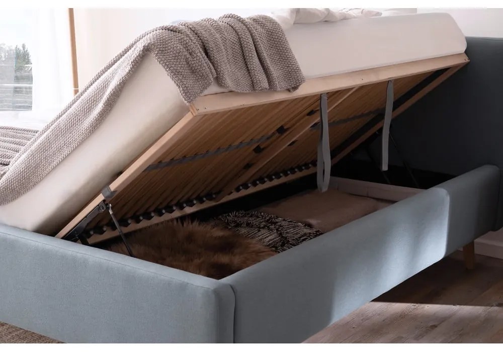 Pat matrimonial albastru prăfuit tapițat cu spațiu de depozitare cu somieră 180x200 cm Mattis – Meise Möbel