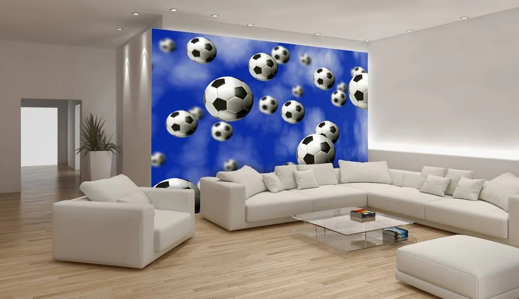 Fototapet - Mingi de fodbal pe fundal albastru (152,5x104 cm)