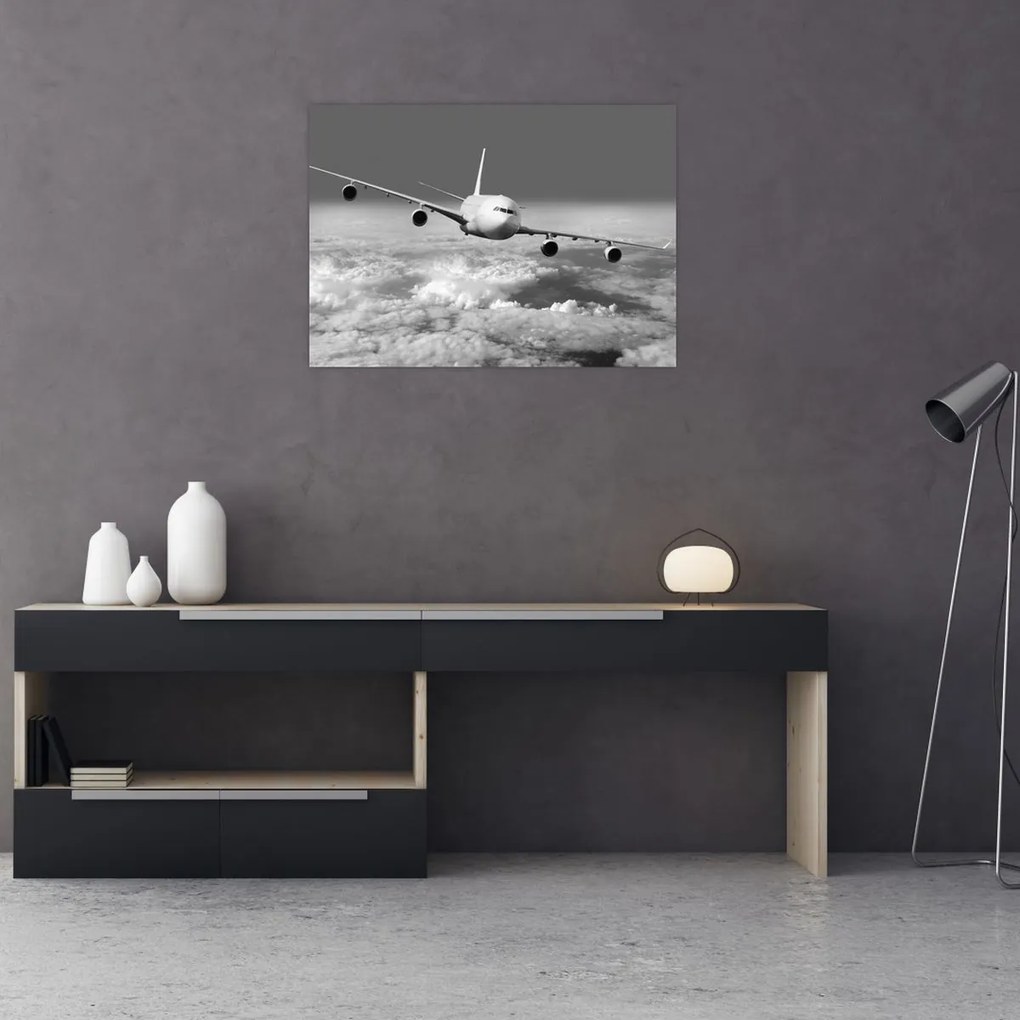 Tablou pe sticlă - Avion în nori, alb și negru (70x50 cm)