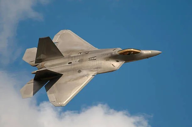 Fotografie F22 Raptor Jet Fighter flying in the sky, JohnnyPowell