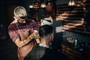 Fotografie One hairdresser cutting hair of a, South_agency