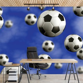 Fototapet - Mingi de fodbal pe fundal albastru (152,5x104 cm)