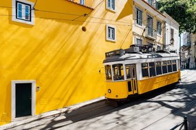 Fotografie Yellow tram moving past yellow building, Alexander Spatari