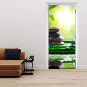 Fototapet pentru ușă - Pietre pentru masaj și orhideele pe masă (95x205cm)