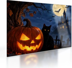 Tablou pe sticlă - Pisică neagră lângă un dovleac luminat de Halloween (70x50 cm)
