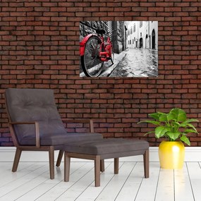 Tablou pe sticlă - Bicicleta roșie pe o stradă pavată (70x50 cm)