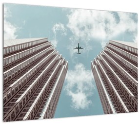 Tablou pe sticlă cuavion între clădiri (70x50 cm)