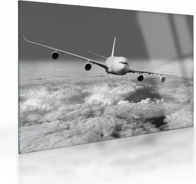Tablou pe sticlă - Avion în nori, alb și negru (70x50 cm)