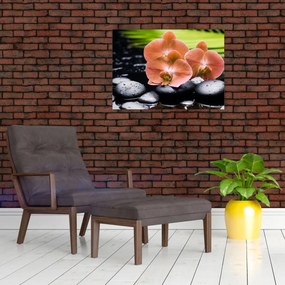 Tablou pe sticlă - Orhidee portocalie cu frunze de palmier (70x50 cm)