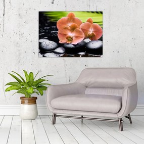 Tablou pe sticlă - Orhidee portocalie cu frunze de palmier (70x50 cm)