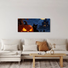 Tablou - Pisică neagră lângă un dovleac luminat de Halloween (120x50 cm)