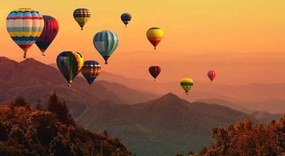 Fotografie Hot air balloon above high mountain at sunset, AppleZoomZoom