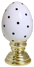 Ou mare alb cu buline negre pe un suport auriu din ceramica