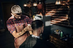 Fotografie One hairdresser cutting hair of a, South_agency