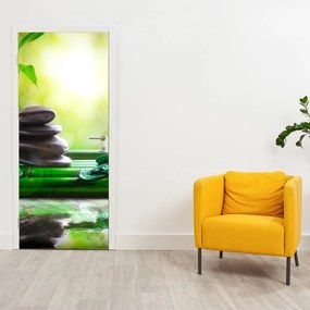 Fototapet pentru ușă - Pietre pentru masaj și orhideele pe masă (95x205cm)