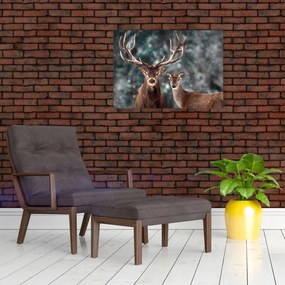 Tablou pe sticlă - Cerb și căprioare în pădurea înzăpezită (70x50 cm)