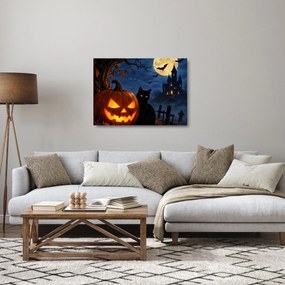 Tablou pe sticlă - Pisică neagră lângă un dovleac luminat de Halloween (70x50 cm)