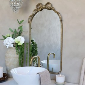 Oglindă decorativă din metal cu finisaj auriu antichizat, cu decor tip panglică, 95x56x4 cm, „Éloise"
