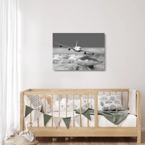 Tablou pe sticlă - Avion în nori, alb și negru (70x50 cm)