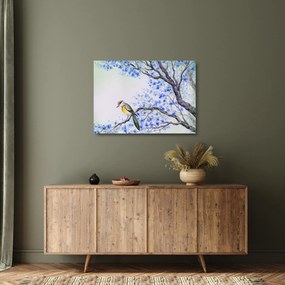 Tablou pe sticlă - Pasăre pe un copac cu flori albastre (70x50 cm)