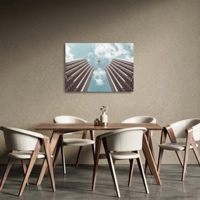 Tablou pe sticlă cuavion între clădiri (70x50 cm)