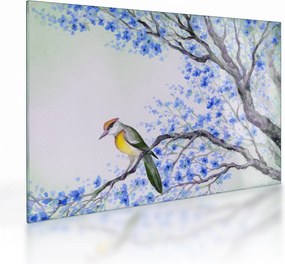 Tablou pe sticlă - Pasăre pe un copac cu flori albastre (70x50 cm)